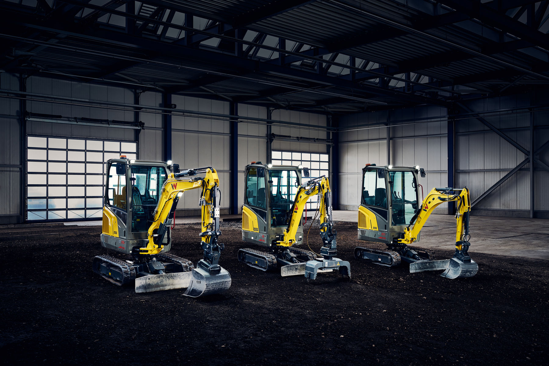 Mini-excavators standing in big hall